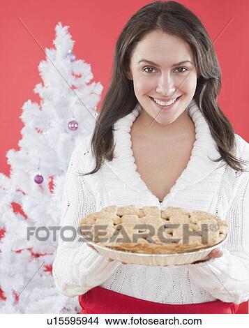 Picture - Woman holding Christmas pie. Fotosearch