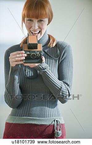 Woman holding vintage camera View Large Photo Image Stock Photo - Woman holding vintage camera. Fotosearch