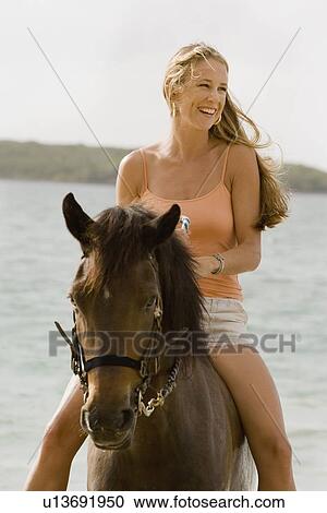 Woman horseback riding View Large Photo Image Stock Image - Woman horseback riding. Fotosearch