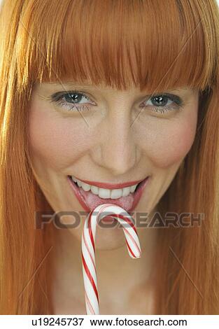 Woman licking candy cane View Large Photo Image Stock Photo - Woman licking candy cane. Fotosearch