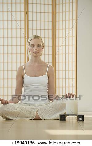 Woman meditating View Large Photo Image Stock Photograph - Woman meditating. Fotosearch