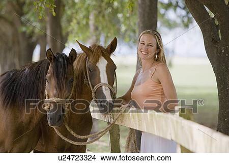 Woman posing with horses View Large Photo Image Picture - Woman posing with horses. Fotosearch
