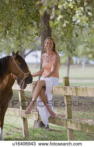 Woman posing with horses View Large Photo Image Stock Image - Woman posing with horses. Fotosearch