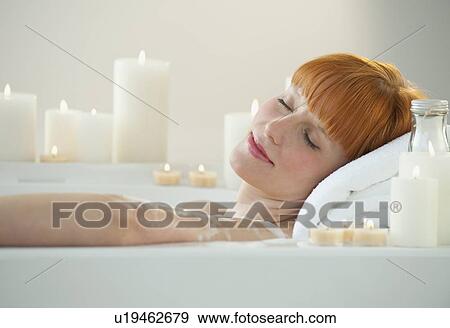 Stock Photo - Woman relaxing in bathtub. Fotosearch
