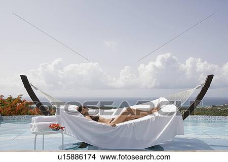 Picture - Woman relaxing in hammock. Fotosearch