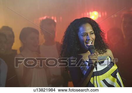 Woman singing karaoke View Large Photo Image Picture - Woman singing karaoke. Fotosearch