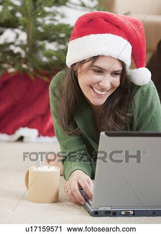 Woman using laptop at Christmas View Large Photo Image Stock Image - Woman using laptop at Christmas. Fotosearch