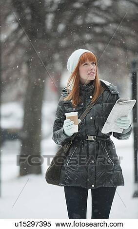 Stock Photography - Woman walking in snow. Fotosearch