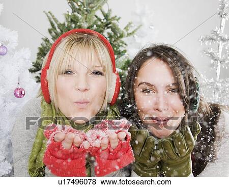 Women blowing snow View Large Photo Image Stock Photo - Women blowing snow. Fotosearch