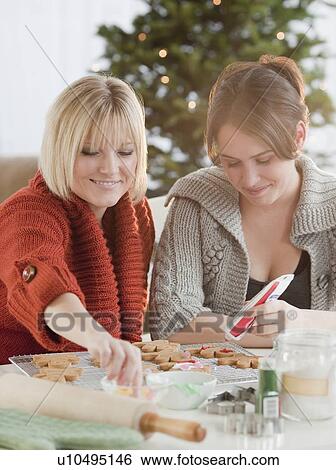 Women decorating Christmas cookies View Large Photo Image Stock Photograph - Women decorating Christmas cookies. Fotosearch