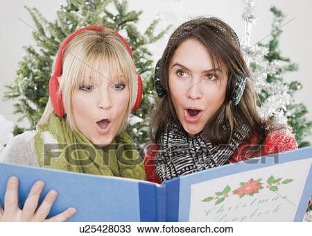 Women singing Christmas carols View Large Photo Image Stock Image - Women singing Christmas carols. Fotosearch