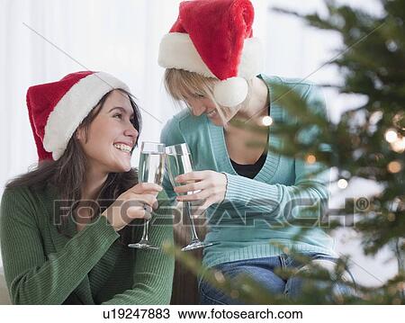Women toasting with champagne at Christmas View Large Photo Image Stock Image - Women toasting with champagne at Christmas. Fotosearch