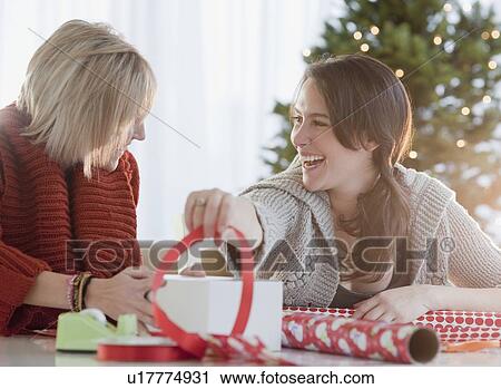 Stock Image - Women wrapping Christmas gifts. Fotosearch