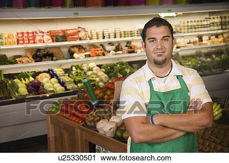 Worker posing in produce section View Large Photo Image Stock Image - Worker posing in produce section. Fotosearch