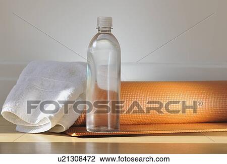 Stock Image - Yoga mat and water bottle. Fotosearch