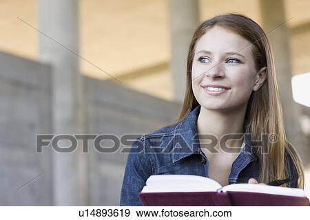Young woman reading in urban setting View Large Photo Image Stock Photo - Young woman reading in urban setting. Fotosearch