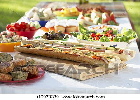 Stock Photo - Al Fresco Dining, With Food Laid Out On Table. Fotosearch