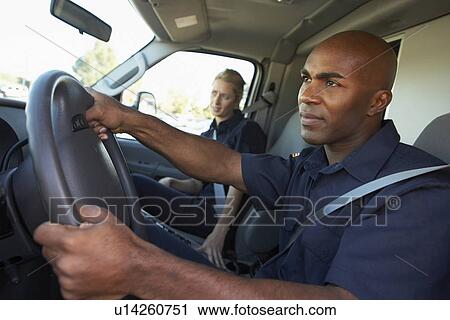 Ambulance driver and colleague on the way to an emergency View Large Photo Image Stock Image - Ambulance driver and colleague on the way to an emergency. Fotosearch