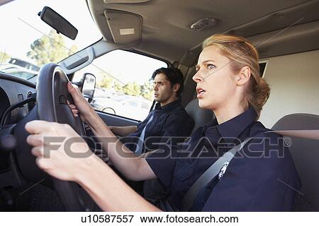 Ambulance driver and colleague on the way to an emergency View Large Photo Image Stock Photo - Ambulance driver and colleague on the way to an emergency. Fotosearch