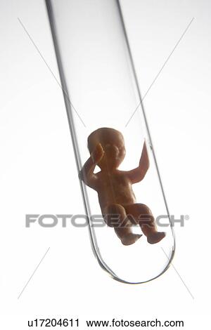 Stock Image - Baby Figurine In A Test Tube. Fotosearch