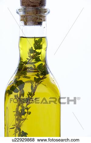 Stock Photo - Bottle Of Olive Oil With Herbs. Fotosearch