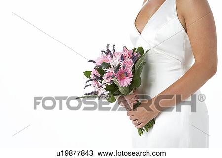 Stock Image - Bride Holding Bouquet Of Flowers. Fotosearch