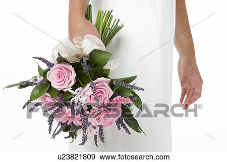 Stock Photo - Bride Holding Bouquet Of Pink Flowers. Fotosearch