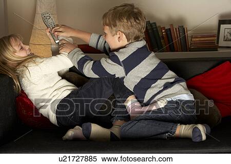 Stock Photography - Brother And Sister Fighting Over Remote Control. Fotosearch
