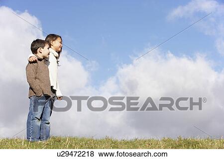 Brother And Sister Standing In The Park View Large Photo Image Stock Photo - Brother And Sister Standing In The Park. Fotosearch