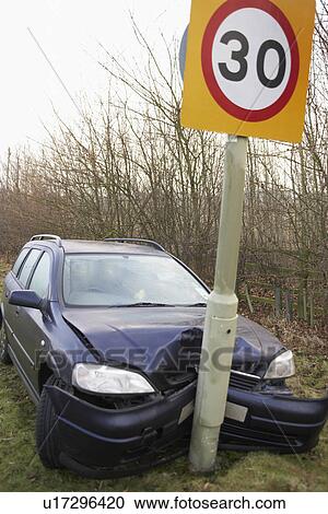 Stock Image - Car Wrapped Around Speed Limit Sign. Fotosearch