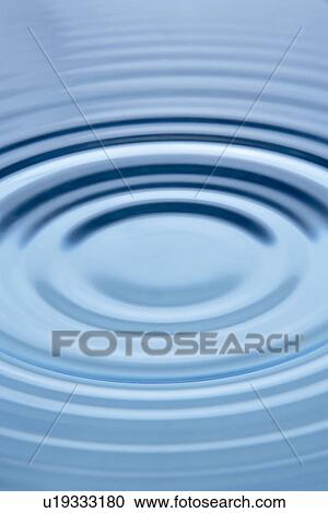 Stock Image - Concentric Circles Forming In Still Water. Fotosearch