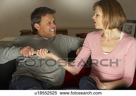 Couple Discussing Choice Of Television Channel View Large Photo Image Stock Photography - Couple Discussing Choice Of Television Channel. Fotosearch