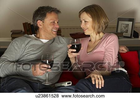 Couple Drinking Wine And Not Watching Television View Large Photo Image Stock Photo - Couple Drinking Wine And Not Watching Television. Fotosearch