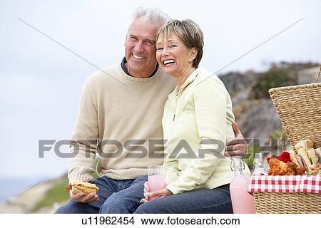 Couple Eating An Al Fresco Meal At The Beach View Large Photo Image Picture - Couple Eating An Al Fresco Meal At The Beach. Fotosearch