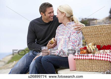 Picture - Couple Eating An Al Fresco Meal At The Beach. Fotosearch