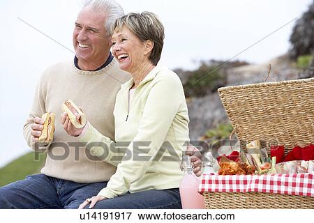 Couple Eating An Al Fresco Meal At The Beach View Large Photo Image Stock Photo - Couple Eating An Al Fresco Meal At The Beach. Fotosearch