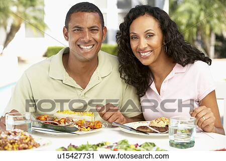 Stock Image - Couple Eating An Al Fresco Meal. Fotosearch