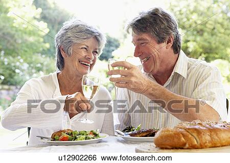 Stock Photograph - Couple Eating An Al Fresco Meal. Fotosearch