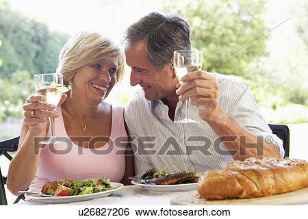 Stock Photograph - Couple Eating An Al Fresco Meal. Fotosearch