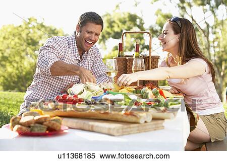Stock Photography - Couple Eating An Al Fresco Meal. Fotosearch