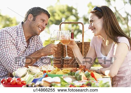 Stock Photography - Couple Eating An Al Fresco Meal, Toasting With Wineglasses. Fotosearch