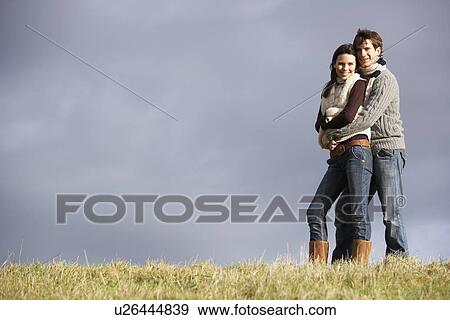 Stock Photo - Couple Embracing In Park. Fotosearch