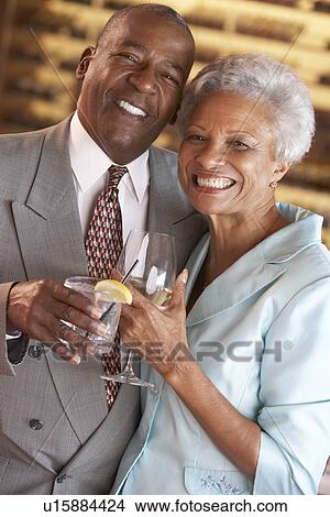 Picture - Couple Enjoying A Drink At A Bar Together. Fotosearch