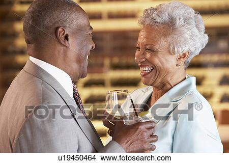 Picture - Couple Enjoying A Drink At A Bar Together. Fotosearch