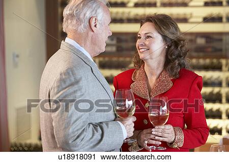 Stock Image - Couple Enjoying A Drink At A Bar Together. Fotosearch
