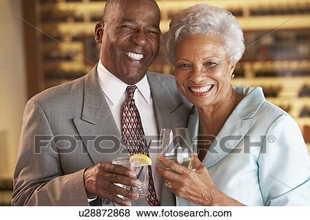 Couple Enjoying A Drink At A Bar Together View Large Photo Image Stock Photo - Couple Enjoying A Drink At A Bar Together. Fotosearch