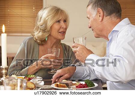 Stock Photograph - Couple Enjoying A Meal At Home Together. Fotosearch