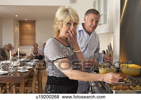 Stock Photo - Couple Having Difficulty Cooking For A Dinner Party. Fotosearch