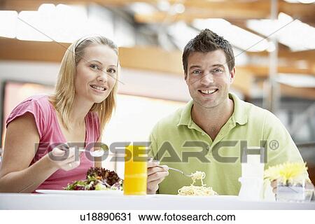 Stock Image - Couple Having Lunch At The Mall. Fotosearch