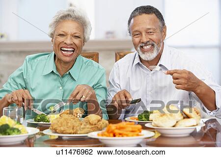 Stock Image - Couple Having Lunch Together At Home. Fotosearch
